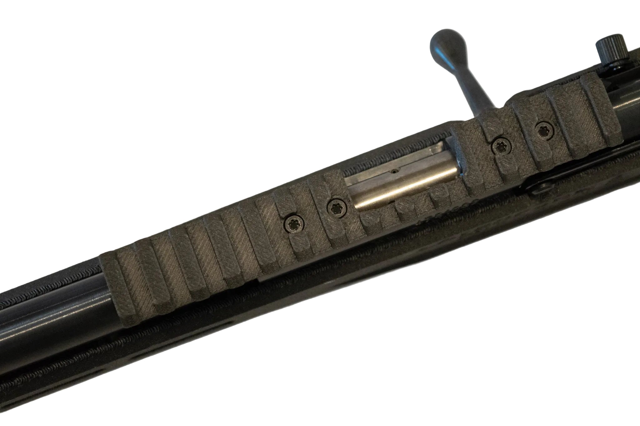 Close-up of a black textured rifle stock or receiver component with a metallic slide and lever on a plain light background.