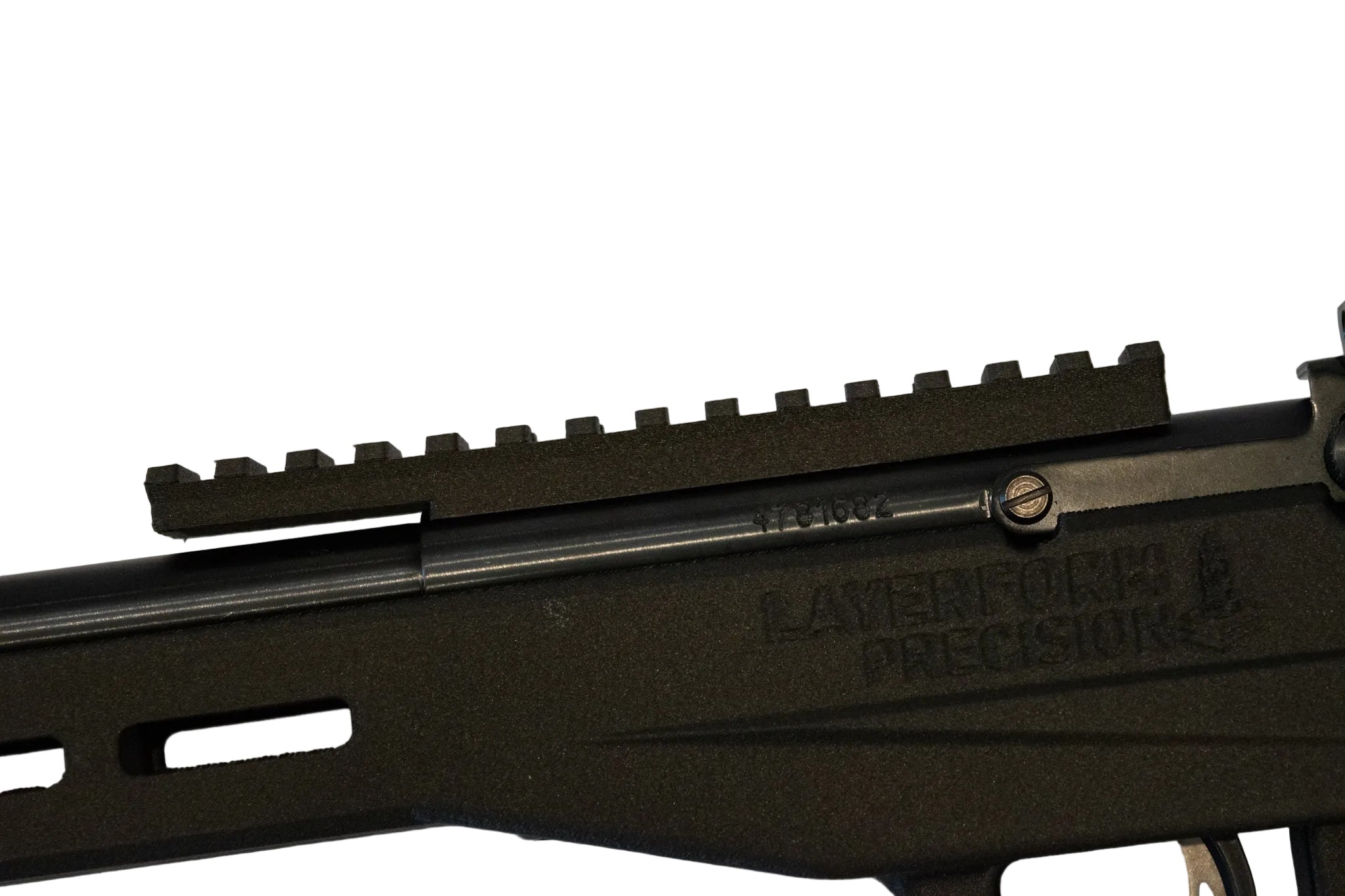 Close-up of a black rifle sight rail mounted over a black Layerform Precision stock, with the Layerform logo embossed on the receiver.