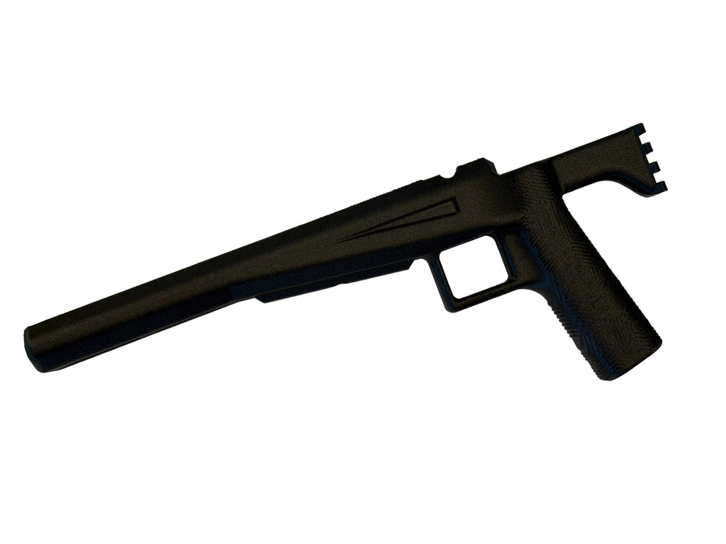 Black firearm on a white surface with a neutral background