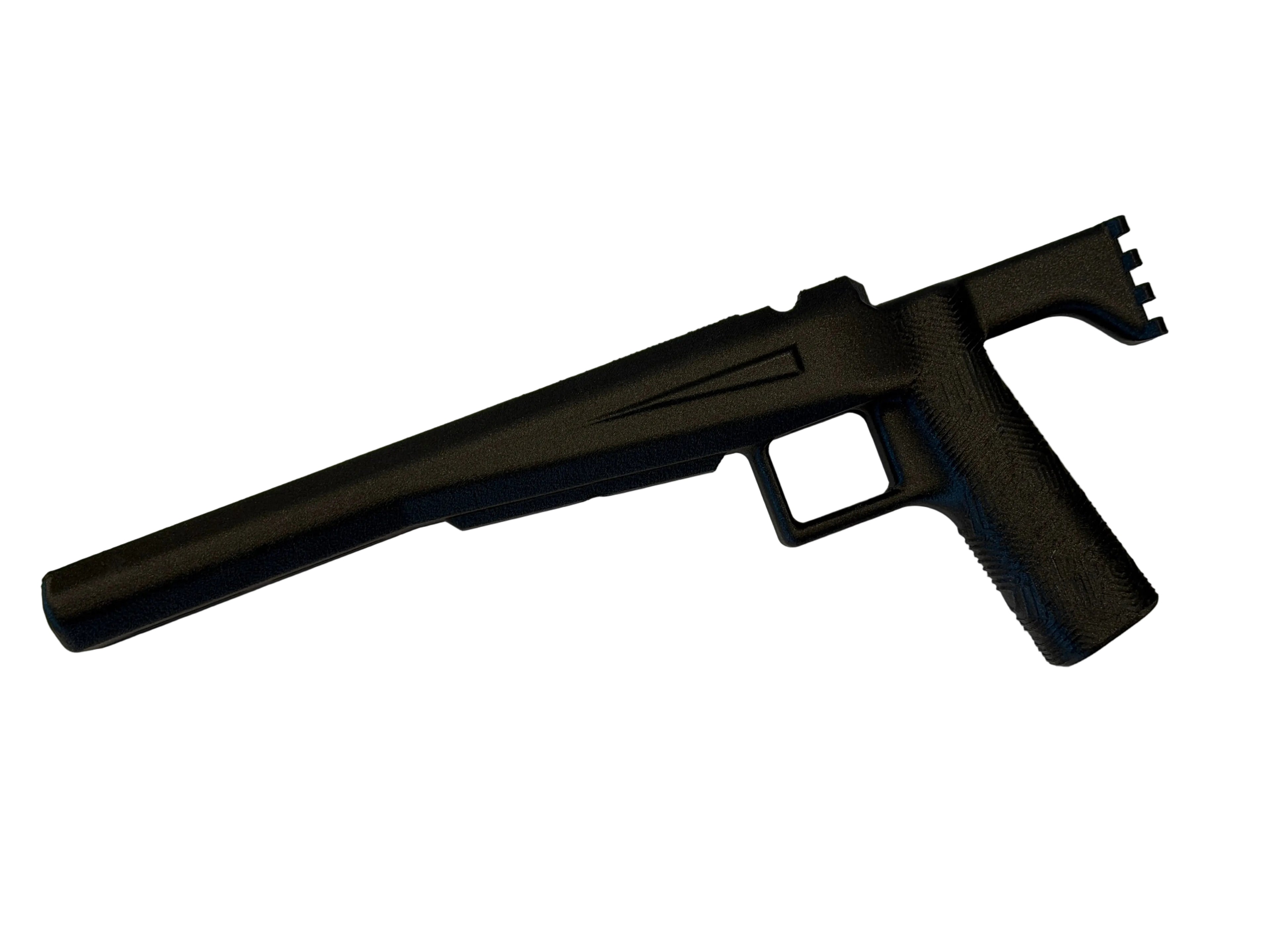 Black firearm on a white surface with a neutral background
