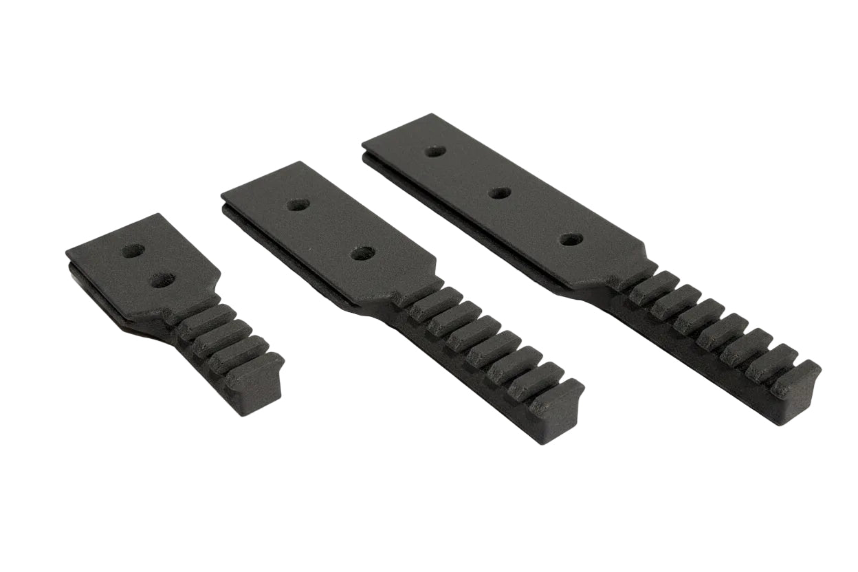 Three black plastic components on a white background
