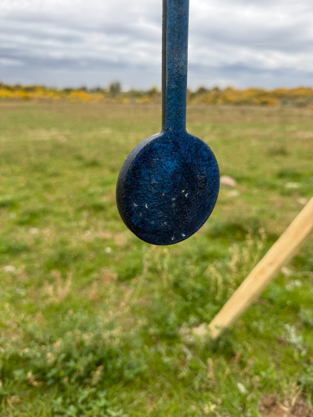 blue hanging target showing healed back where bullets have exited
